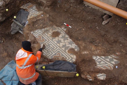 Archaeologists excavate the high-status mosaic floor.